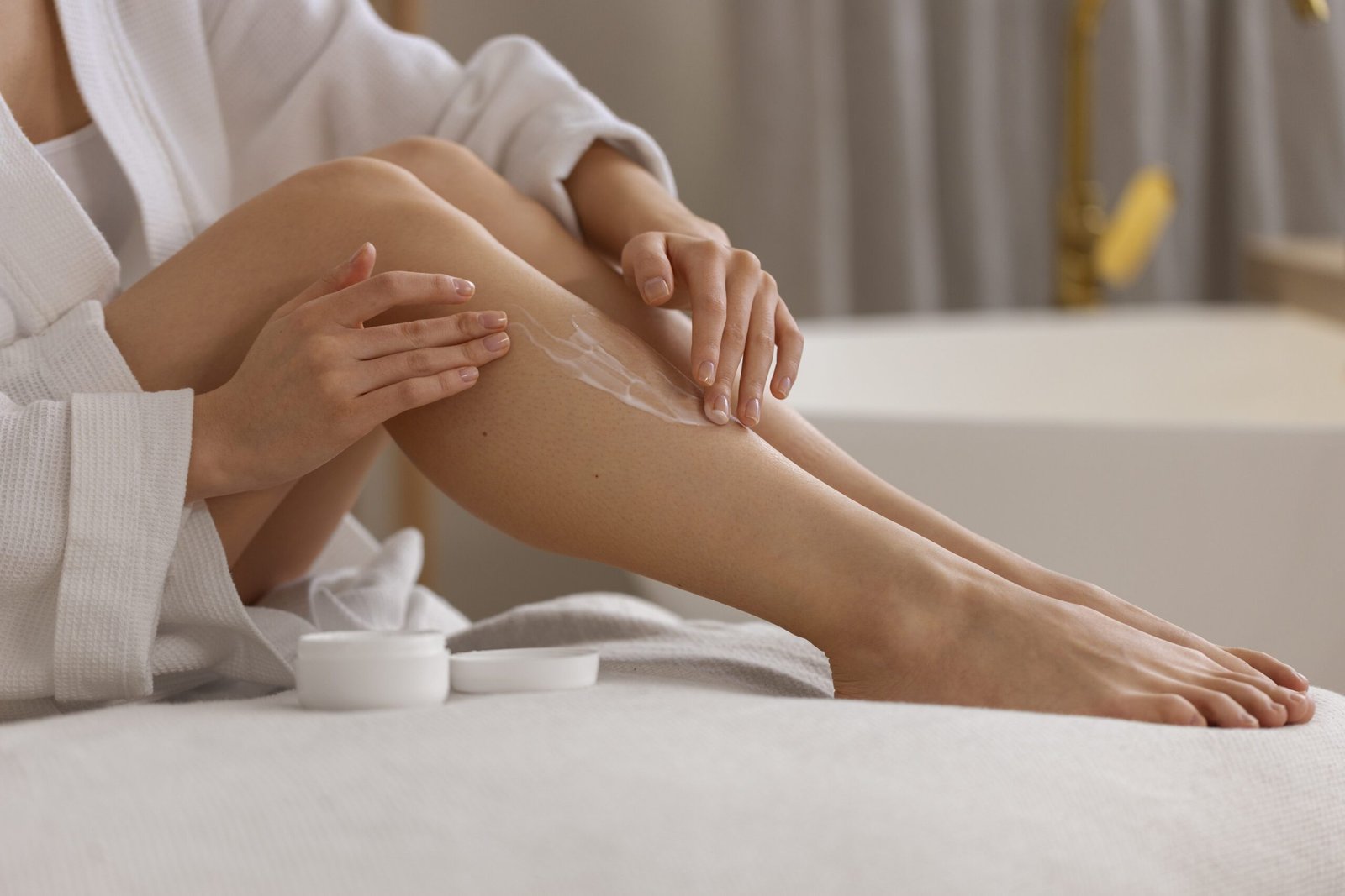 side view woman using cream